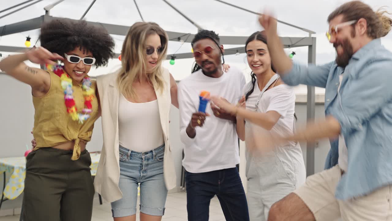 Group of friends singing karaoke and celebrating