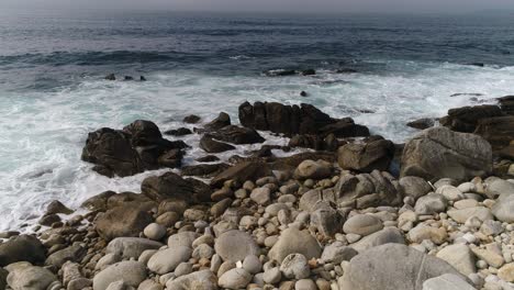olas chocando contra las rocas del mar