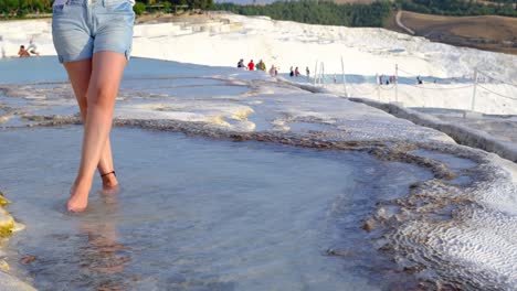 pamukkale, natural site in denizli province in southwestern turkey. tourist young woman spends her holiday in pamukkale.