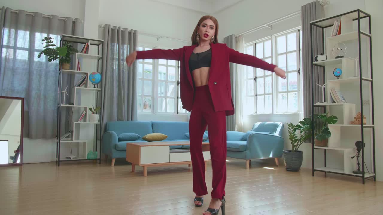 Young Fashion Transgender Woman Wearing Red Clothes Walking And Posing In Home