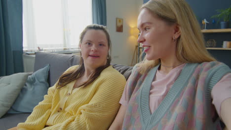 pov of woman and girl with down syndrome chatting on video call