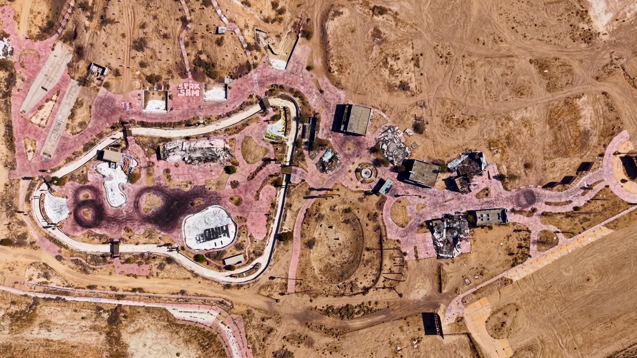 High altitude drone shot looking down at the Ruins of Lake Dolores Waterpark. This view reveals the size of the once bustling waterpark, now left to decay in the desert sun
