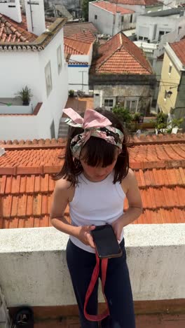 girl with smartphone on a rooftop