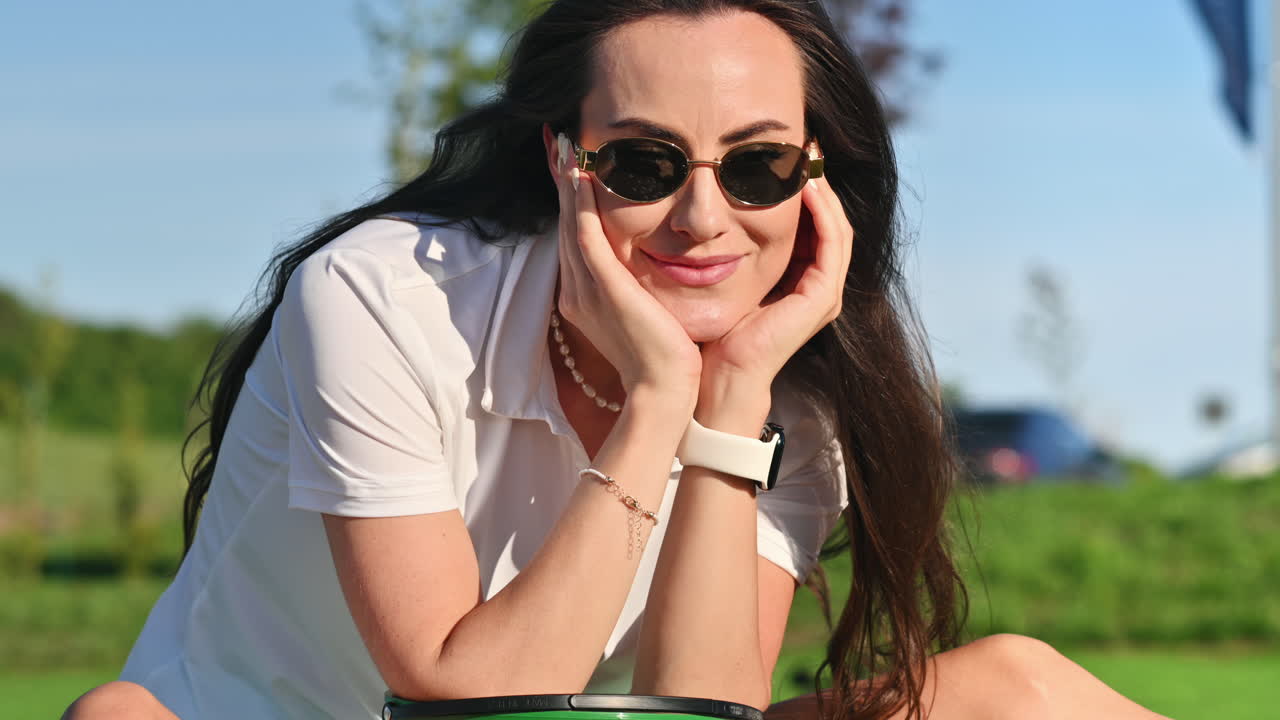 Woman in green skirt standing on the golf course near a bucket with balls