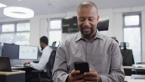 group of happy diverse business people using smartphone and working in office, slow motion