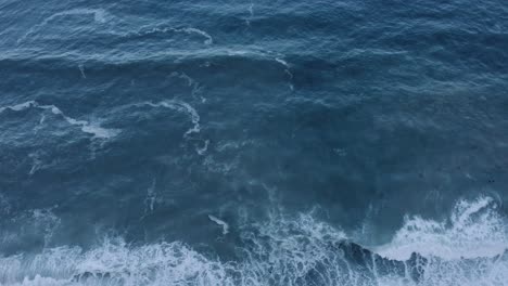 aerial ocean waves breaking at dusk 4k