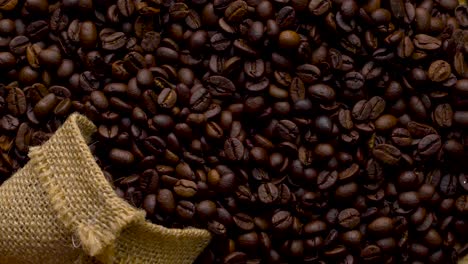 4k footage. 4096x2304p.fragrant coffee beans are roasted in a frying pan, smoke comes from coffee beans. the whole composition scrolls slowly around the camera. scoop stir coffee beans.