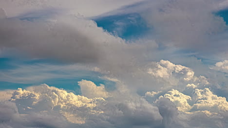 Timelapse-shot-of-white-fluffy-clouds-moving-along-blue-sky-at-daytime