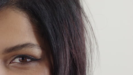 close up hispanic woman eye opening looking happy emotion wearing makeup cosmetics on white background