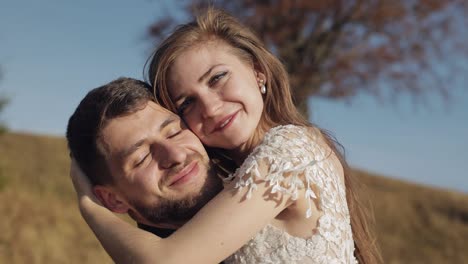 Newlyweds.-Caucasian-groom-with-bride-near-beautiful-autumn-tree.-Wedding-couple