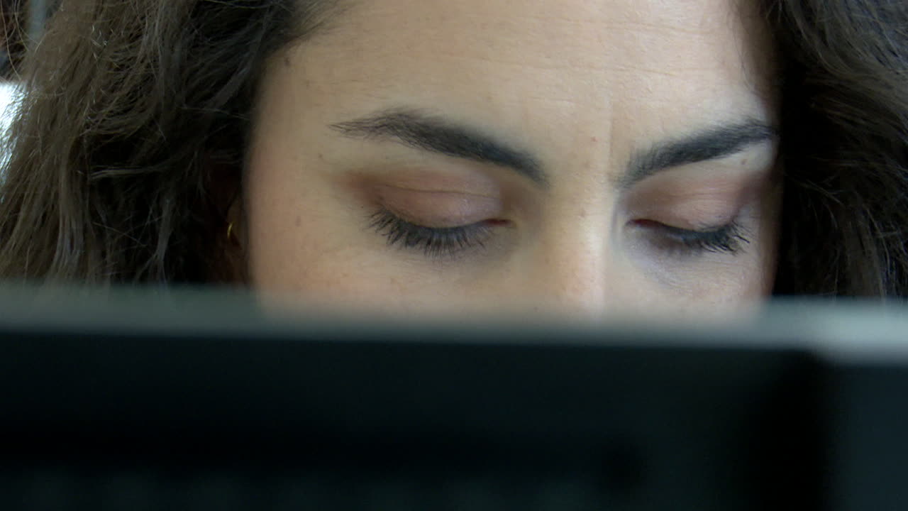 Woman Concentrating on a Laptop