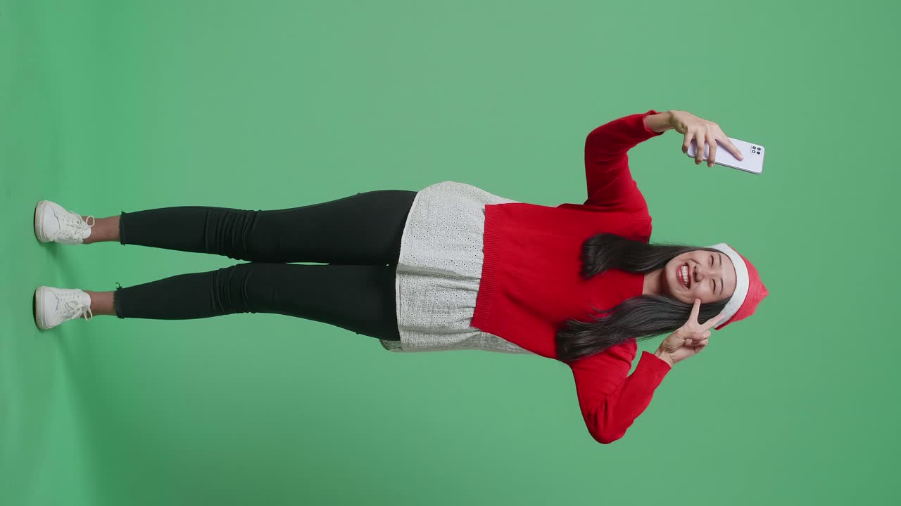 Woman taking a Christmas Selfie