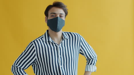 man wearing a face mask in a striped shirt