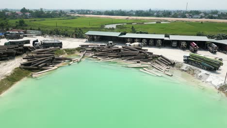 industrial complex with lumber, concrete, and water feature