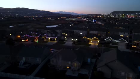 flying over a suburban neighborhood in lehi, utah at night on christmas and seeing houses decorated with colorful lights