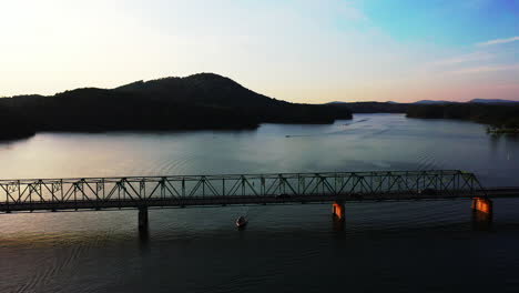 Romantic-view-of-truss-bridge-over-water-surface-at-twilight