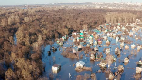 several houses are flooded by the river. spring flood outlook . mass natural disasters and destruction. background of the spring woods.