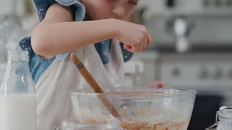 cute little girl baking mixing ingredients in bowl preparing recipe for homemade cupcakes having fun making delicious treats in kitchen 4k