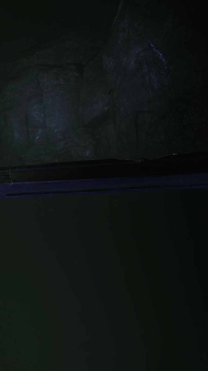 Light reflects on flat surface in dim space at night