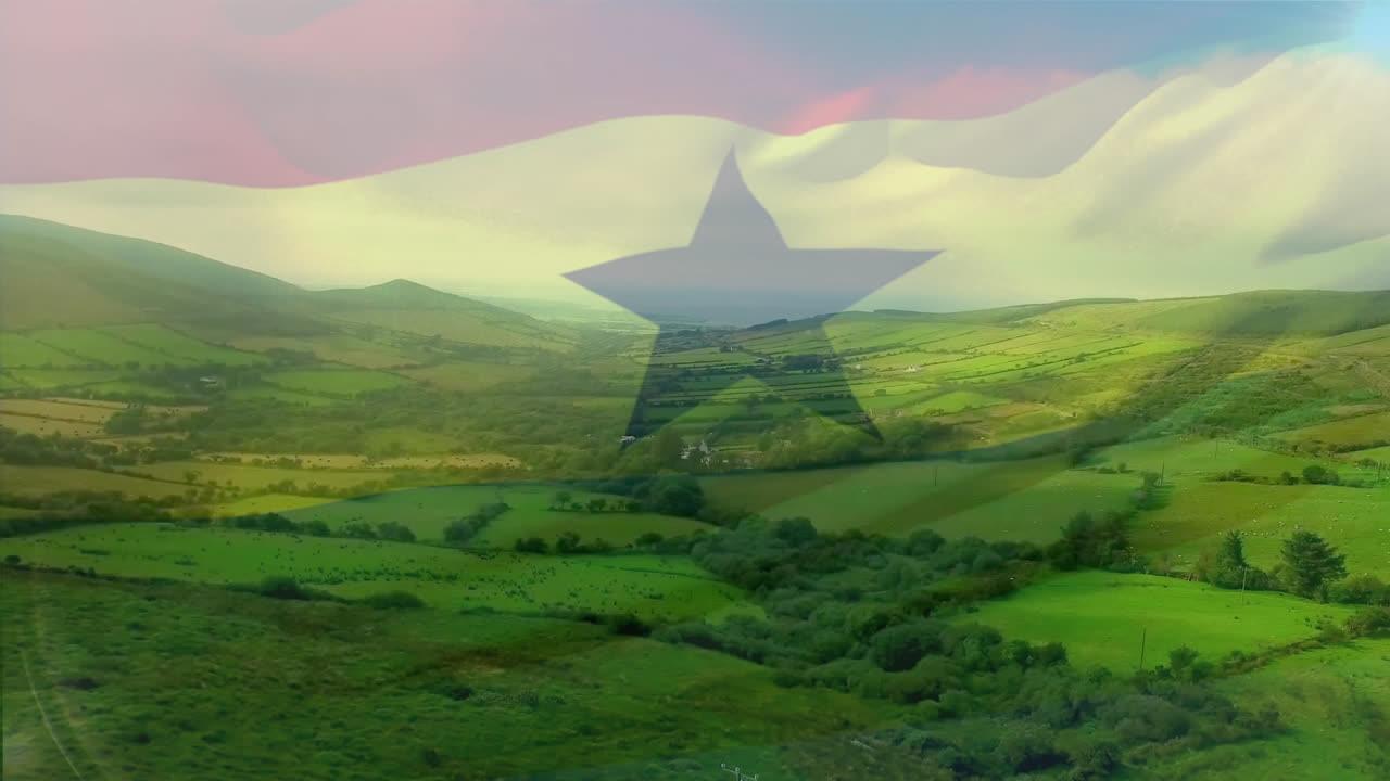 composición digital de la bandera de ghana ondeando contra una vista aérea de las praderas