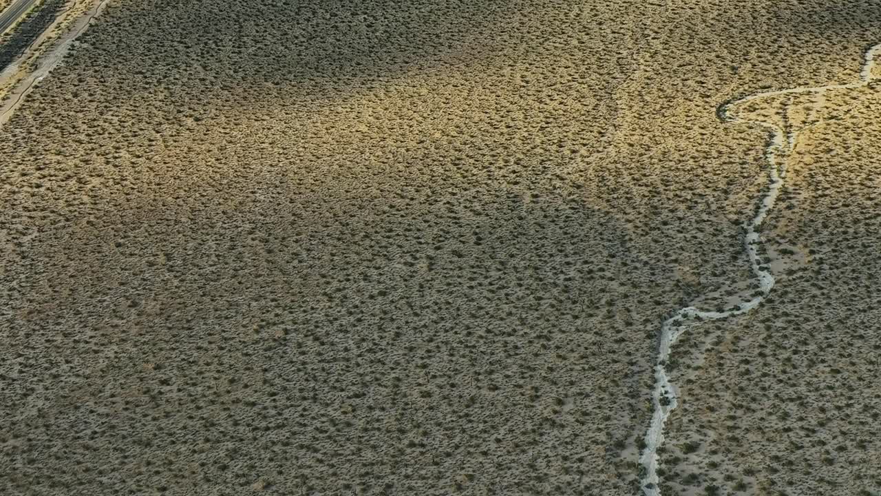 Aerial view of dry landscape with winding creek in USA