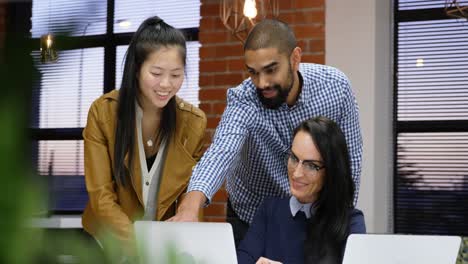 executives discussing over laptop in office cafeteria 4k