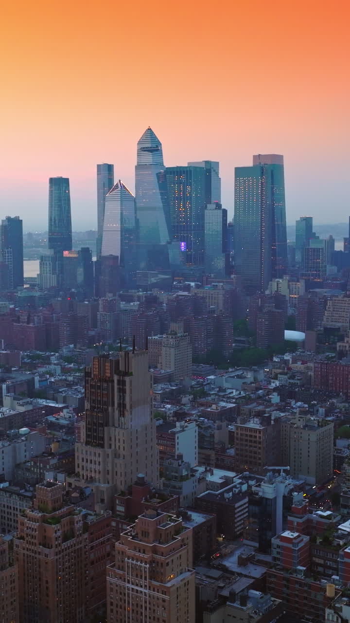Splendid Manhattan panorama at sunset. Ascending drone footage over the magnificent architecture at the backdrop of pink sky. Vertical video