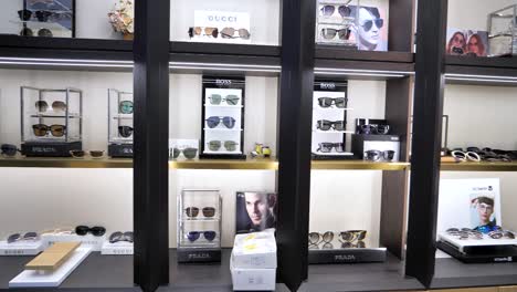 a vibrant view of a shopping mall showcase filled with a wide array of stylish sunglasses, capturing the essence of consumer trends in danyang, jiangsu province, china.