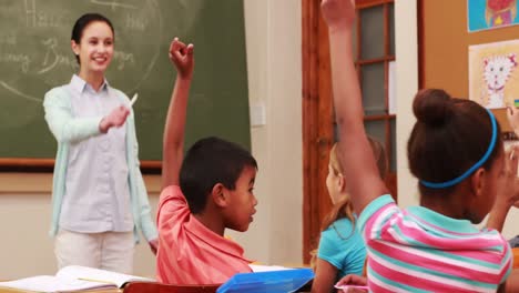 pupils raising their hands during class