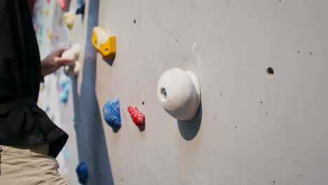 person rock climbing on an indoor climbing wall