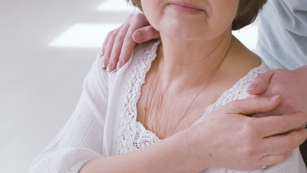 Close Of Of A Domestic Grey Cat Sniffing And Licking Catnip While On Blurred Background Woman Sitting On Floor