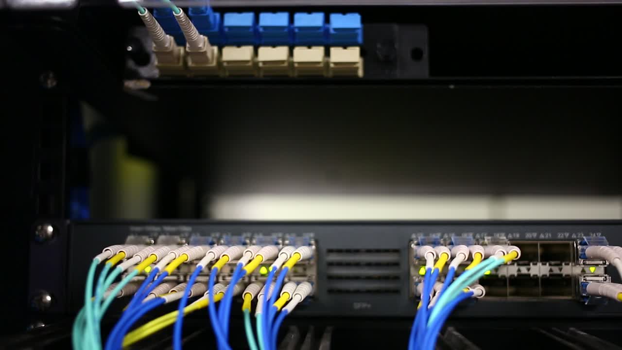 las luces parpadean en la parte posterior de un servidor lleno de cables de ethernet conectados