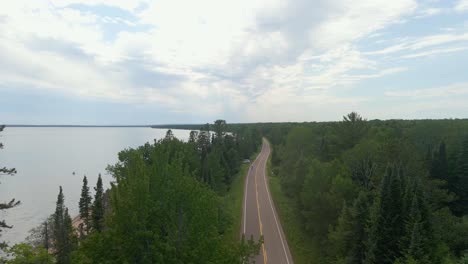 Aerial-view-drone-shot-of-a-pretty-scenic-drive-in-Madeline-island,-freeway-with-a-view