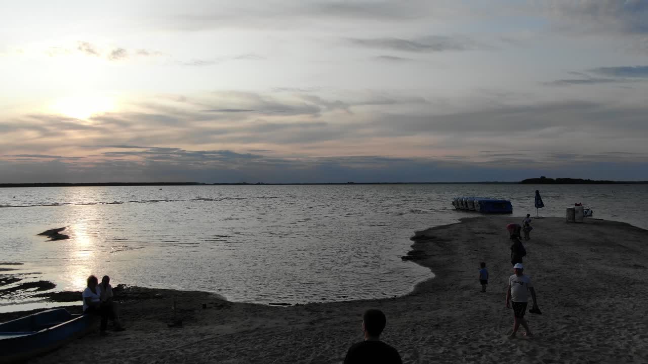 Aerial View of Man Riding a Hoverboard on a Dock Towards Lake During Sunset