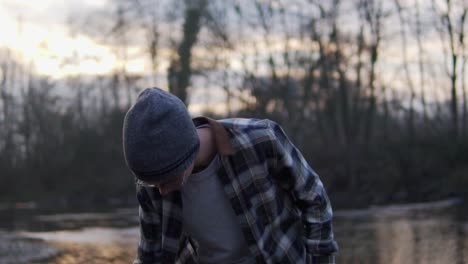 Guy-standing-next-to-river