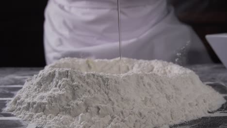 chef pouring an egg onto flour