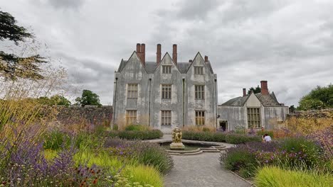 stately home surrounded by vibrant, colorful gardens