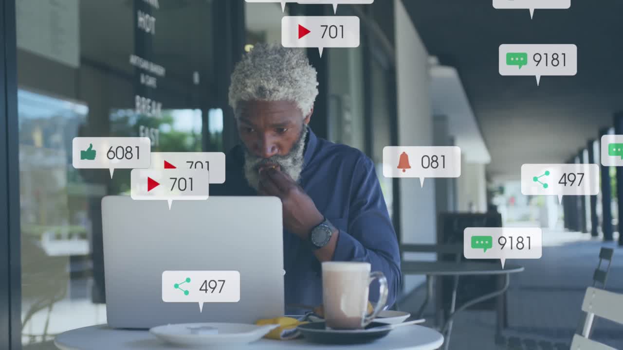 Animation of social media icons and numbers over african american businessman with laptop