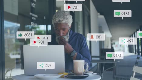 Animation-Von-Social-Media-Symbolen-Und-Zahlen-über-Einem-Afroamerikanischen-Geschäftsmann-Mit-Laptop
