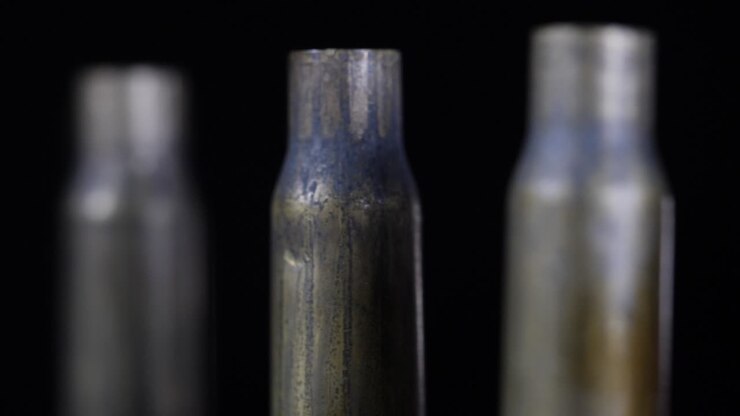 Close-up rotating shot of bullet shells standing all in a row