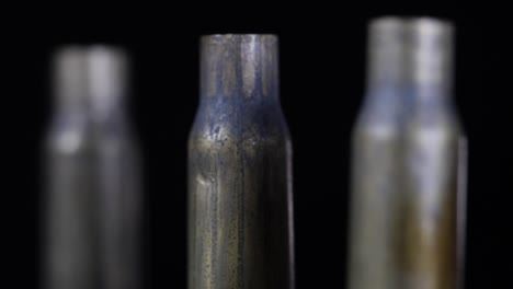 close-up rotating shot of bullet shells standing all in a row