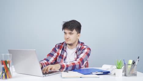 Man-looking-at-laptop-making-positive-gesture.