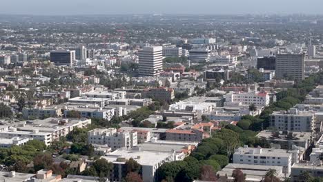 aerial rising shot view of santa monica cityscape with variety of large and small buildings