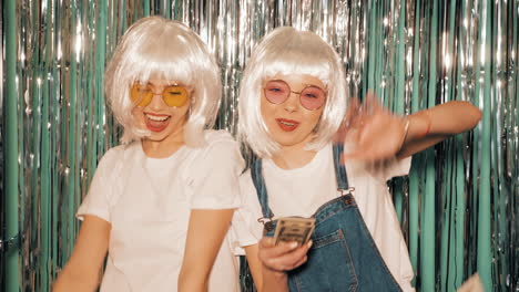 two women having fun in a photo booth