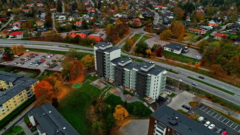 aerial drone forward moving shot over a building complex with a park in stockholm, sweden on a cloudy day