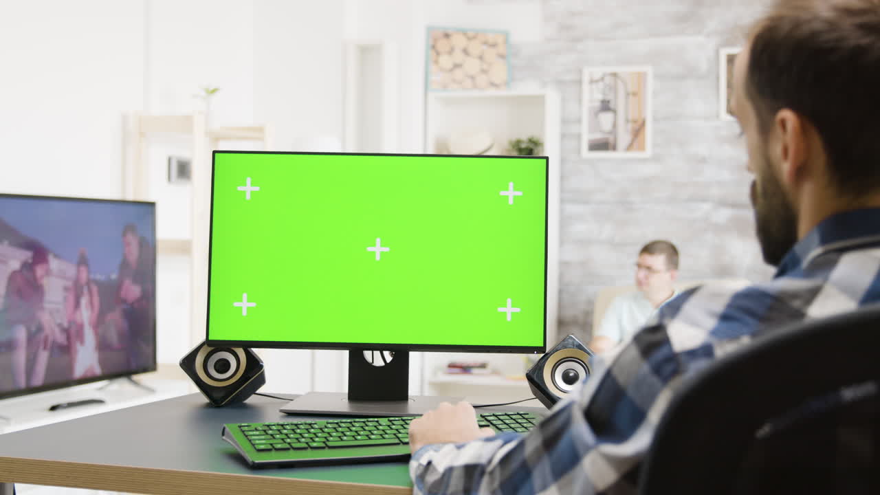 Person working with computer with green screen