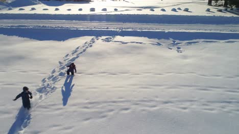 kids playing on a snowy area 4k