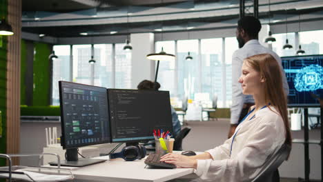cheerful startup manager satisfied with progress of intern learning to use ai