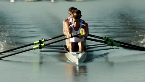 rowers competing in a scull boat on water