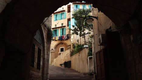 walking-through-archway-in-old-middle-eastern-alley-way-in-Tripoli,-Northern-Lebanon